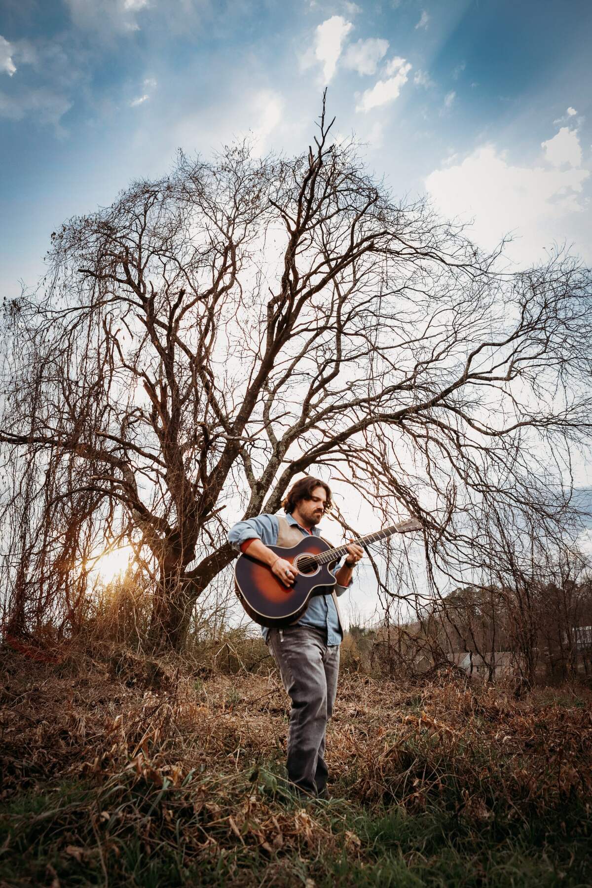 Spencer Scott Smith with his guitar at golden hour